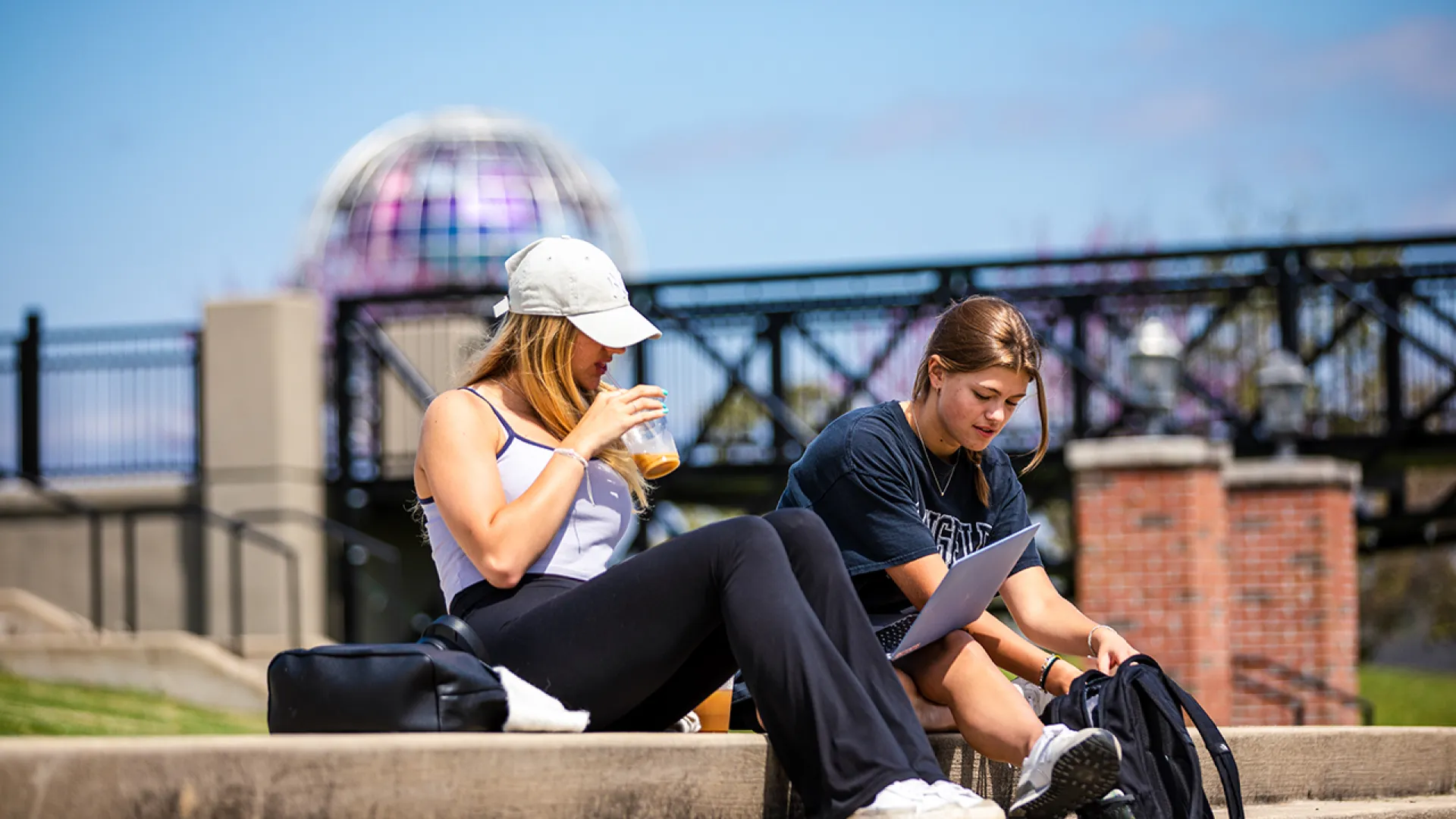 Two students relax near the campus center. 