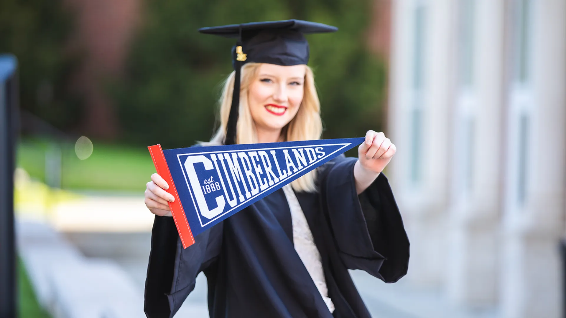 A graduate shows off her Cumberlands pennant 