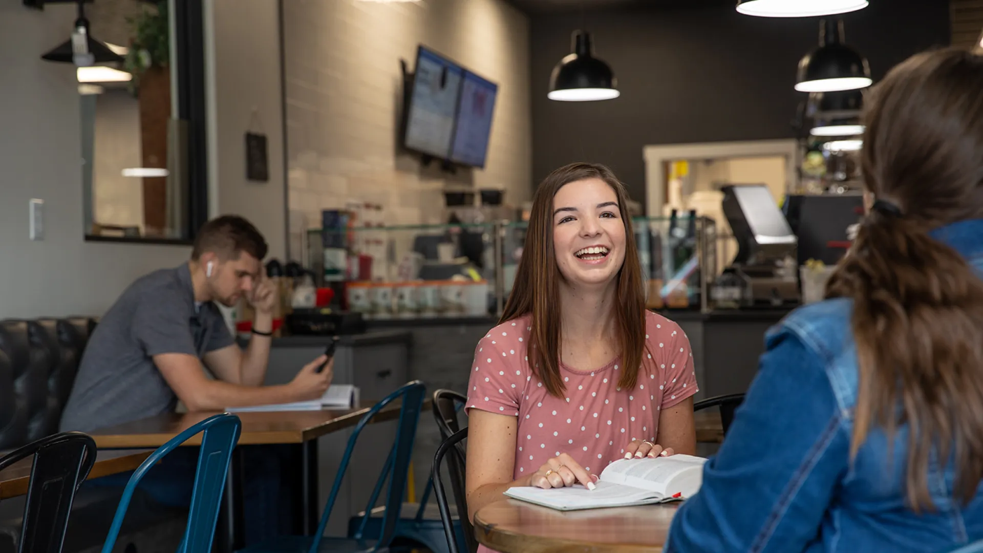 A Cumberlands student studies her Bible at a coffeeshop
