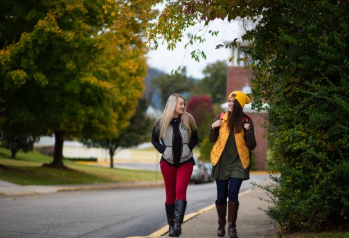 Two students on a sidewalk