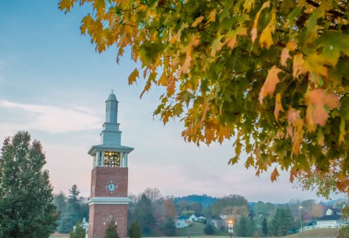 Fall leaves next to tall clock tower