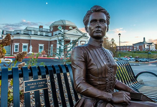 A statue of Marie Curie in front of the Correll Science Building