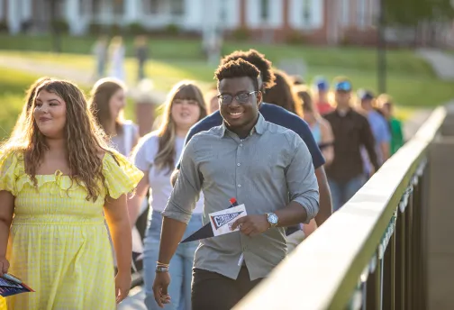 Graduating seniors walk across the viaduct. 