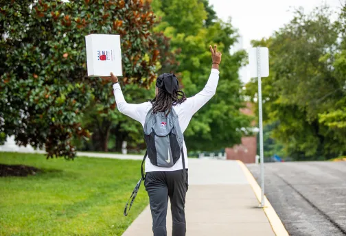 Guy holding up a package