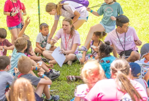 Children sitting in a circle outdoors