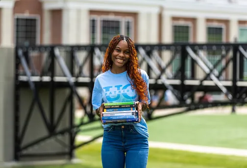 girl holding textbooks