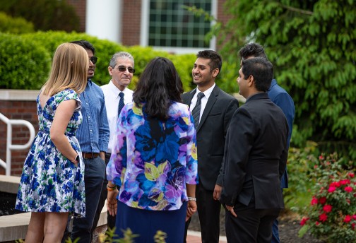 Executive students and professors talking together