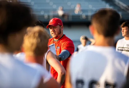 Football coach instructs players