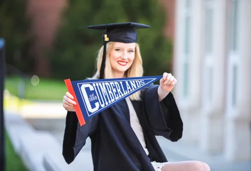 A graduate shows off her Cumberlands pennant 