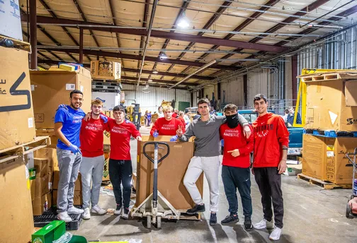 guys standing in a warehouse