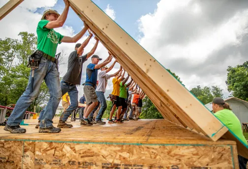 Volunteers build walls at a Mountain Outreach home