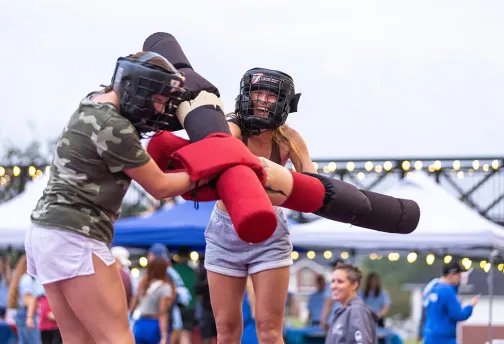 two friends jousting