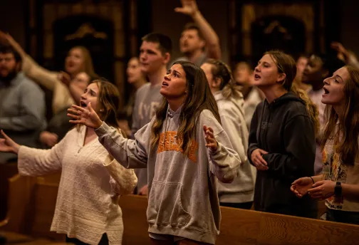 Student sing during a worship event