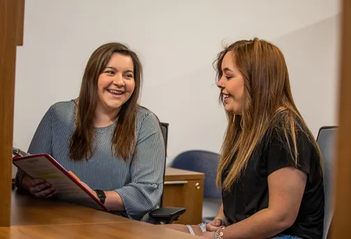 Adult talking with a student