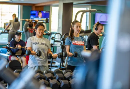 young adults working out in a weight room