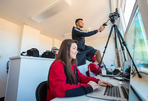 students using laptop and video camera