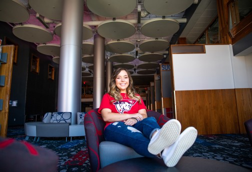 A student relaxes in the library lounge