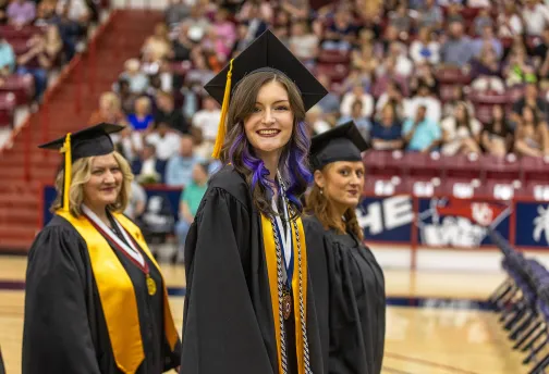 A student walks into her graduation ceremony. 