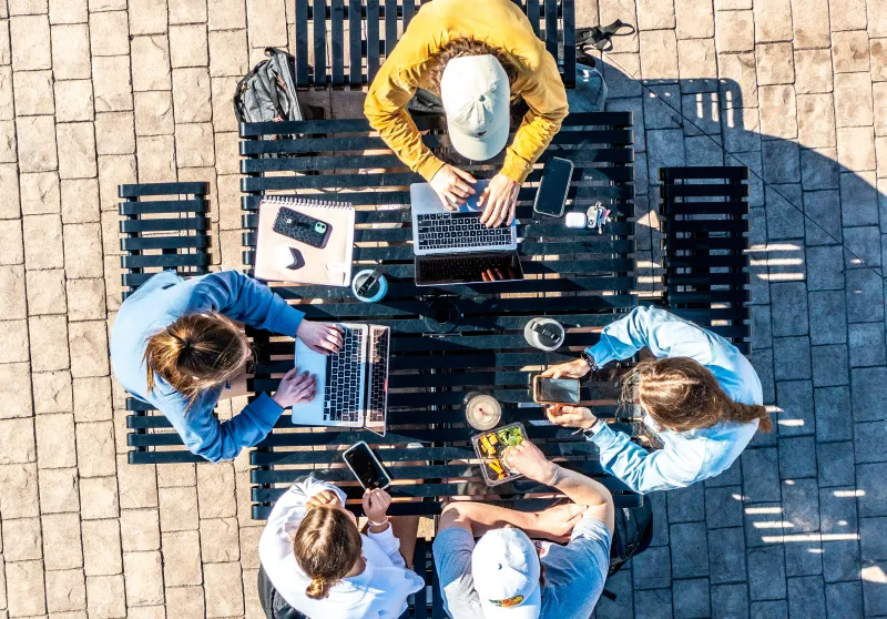 An aerial footage of several students studying outside