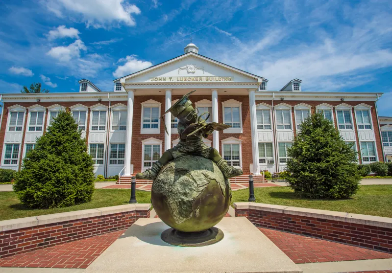 Bronze statue in front of a campus building