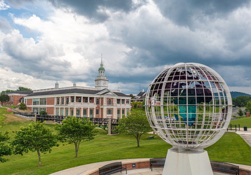 Large globe statue in front of campus building