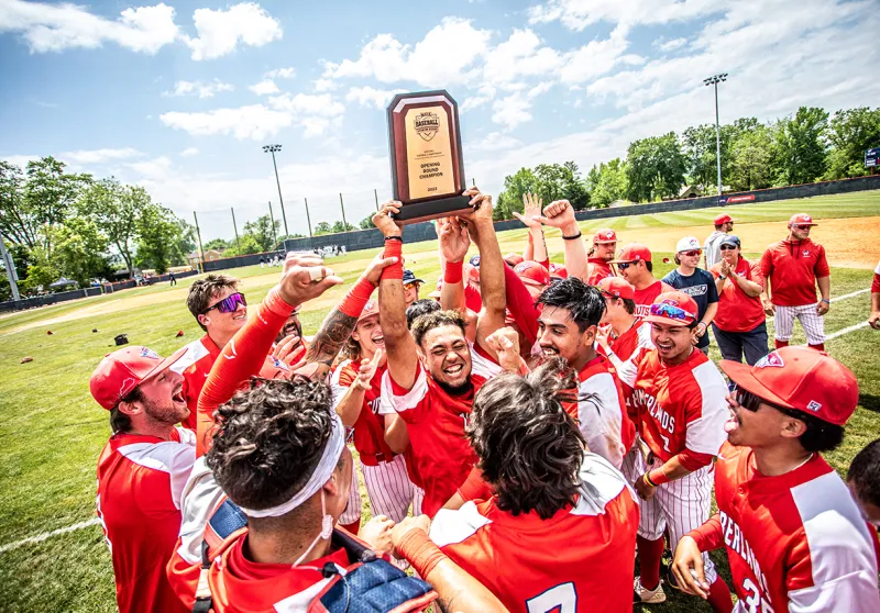 The Patriots baseball team celebrates winning the opening round of the MSC tournament.