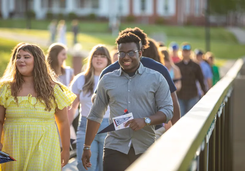 Graduating seniors walk across the viaduct. 