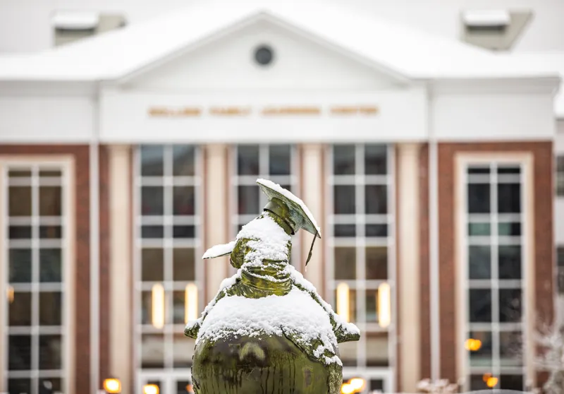 Snow falls on our academic statue on campus. 