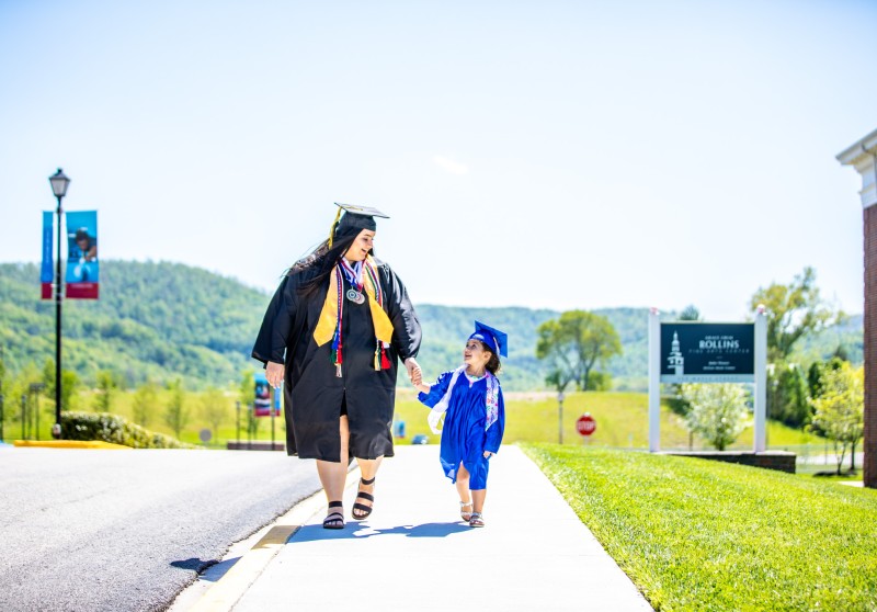 A woman and child both wearing cap and gown