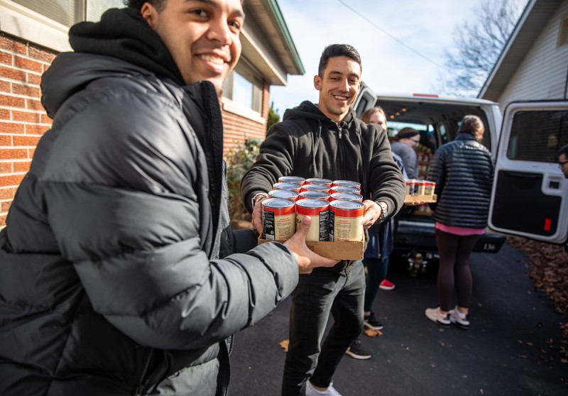 Students unload food at a local church during the food drive