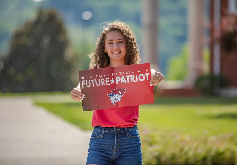 Student holding Future Patriot packet