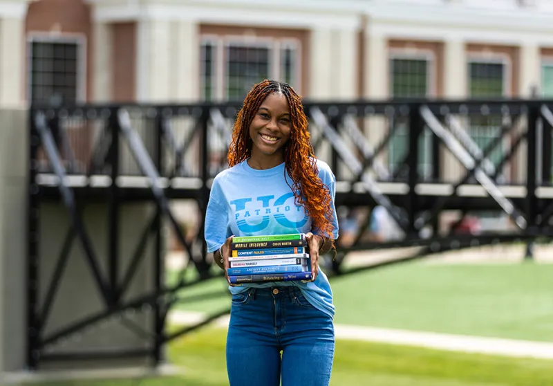girl holding textbooks