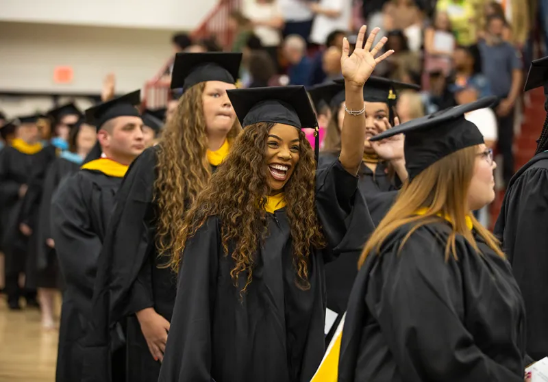 A group of Graduate students entering during the processional at Commencement.