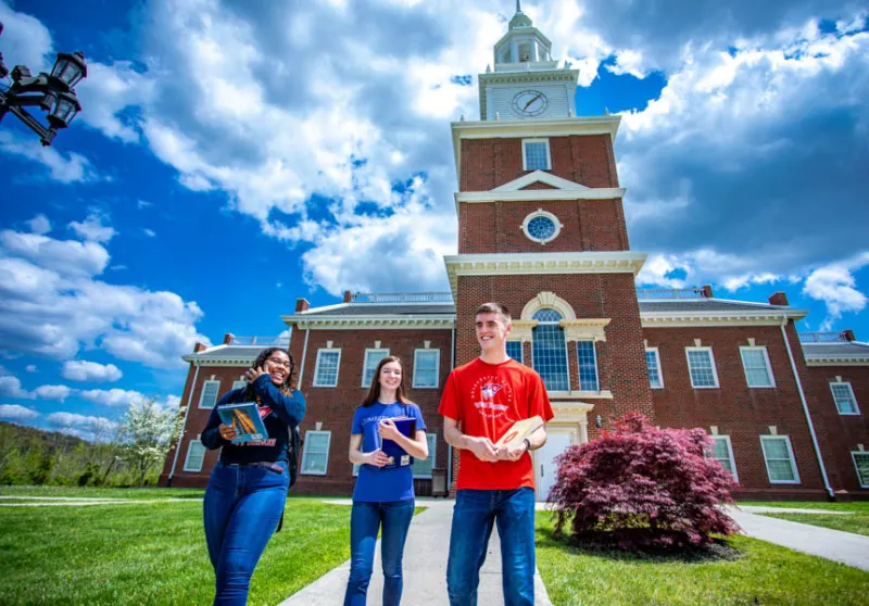 Students walk outside Hutton School of Business