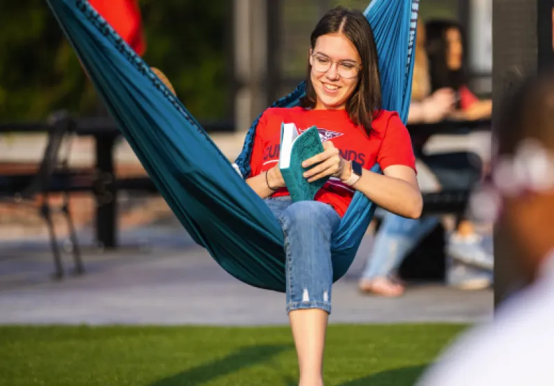 FPO student in hammock reading
