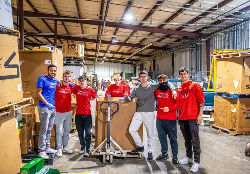 guys standing in a warehouse