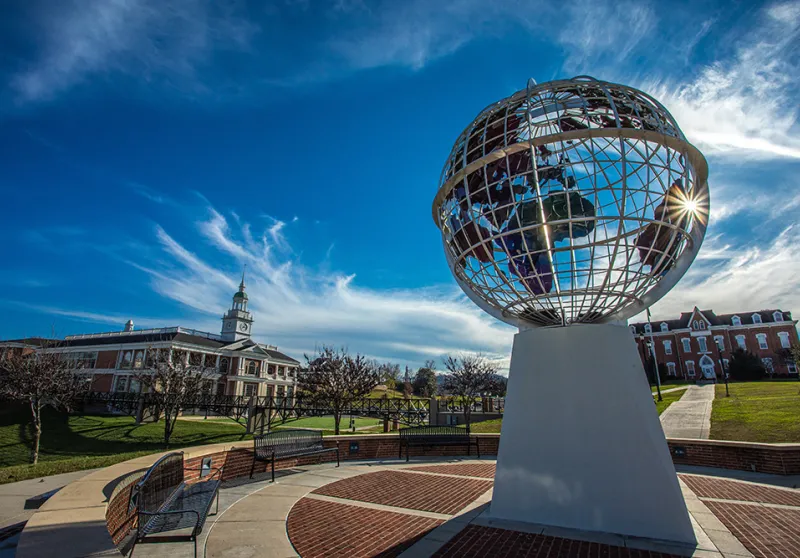 A picture of the campus showing the globe statue 