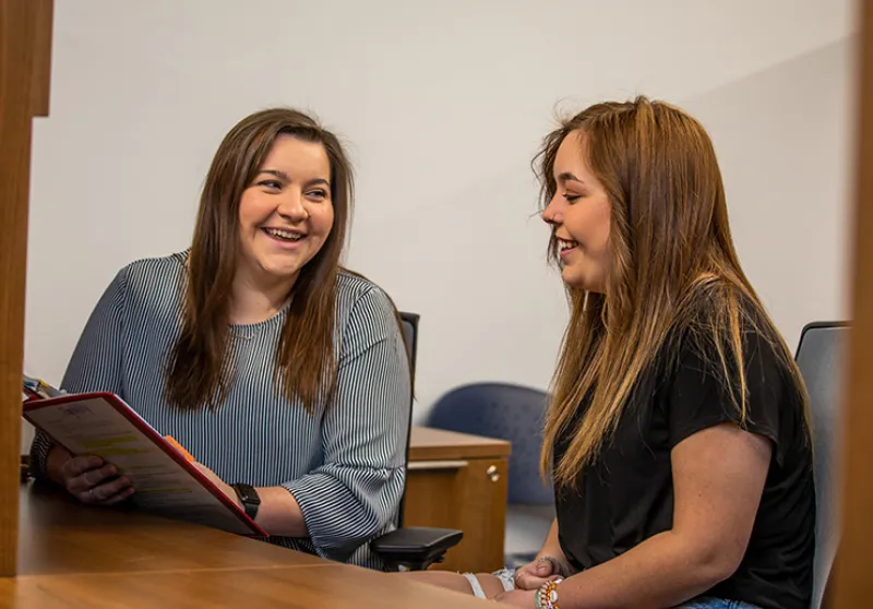 Adult talking with a student