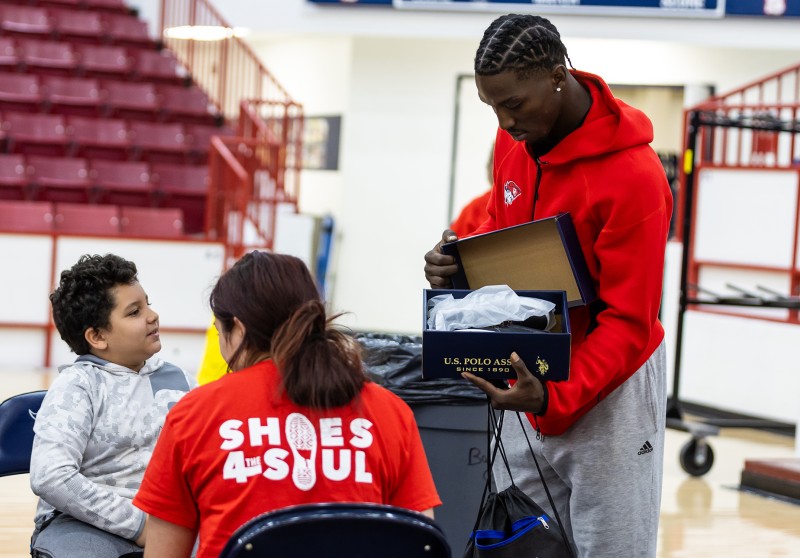 Cumberlands students show a student from a local school a pair of new shoes during Shoes 4 the Soul. 
