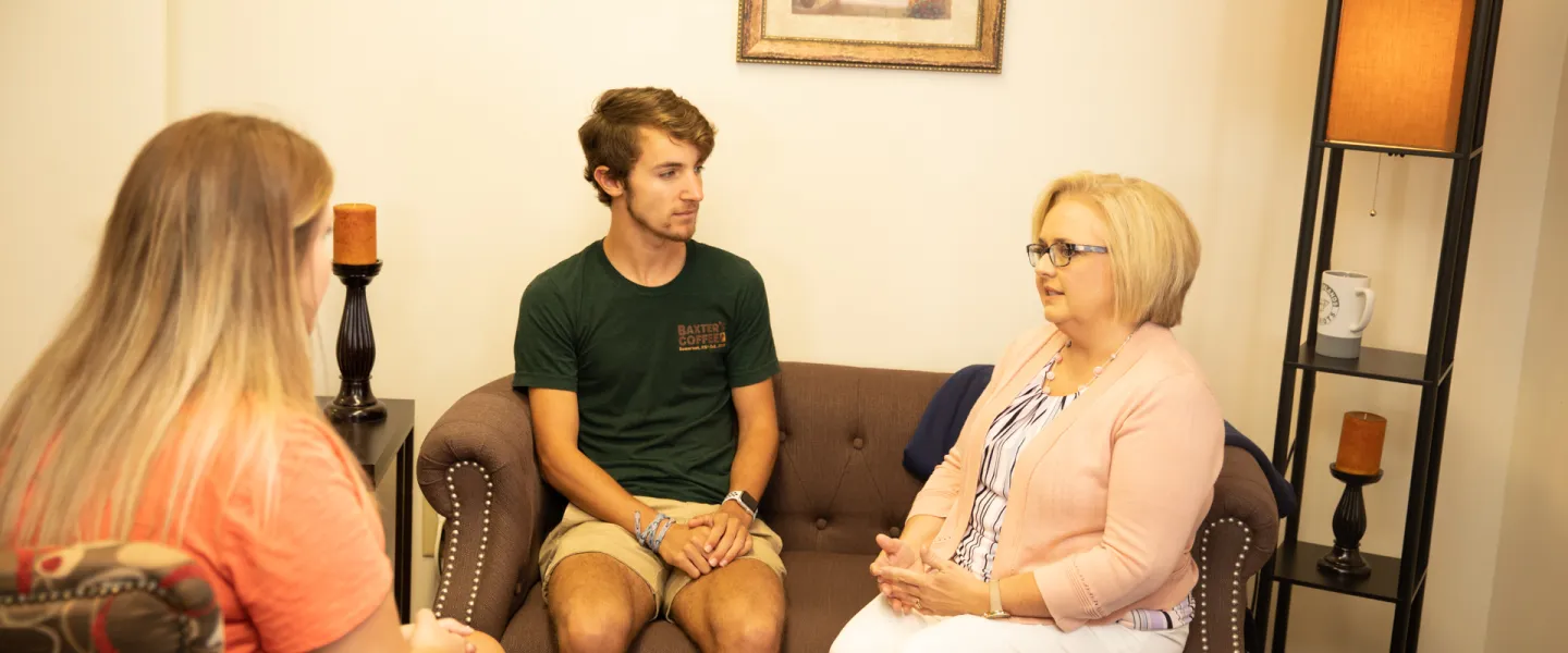 Counselor sitting in a room with two other people