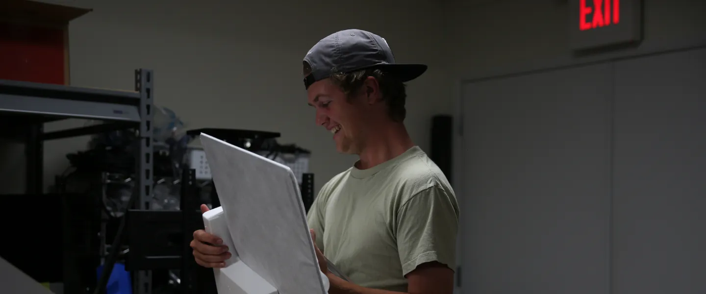A student placing an item into styrofoam