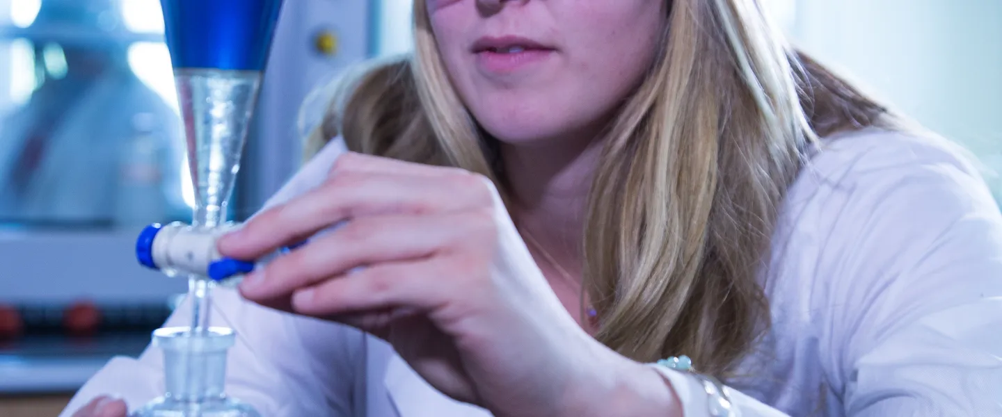 A chemist mixing chemicals