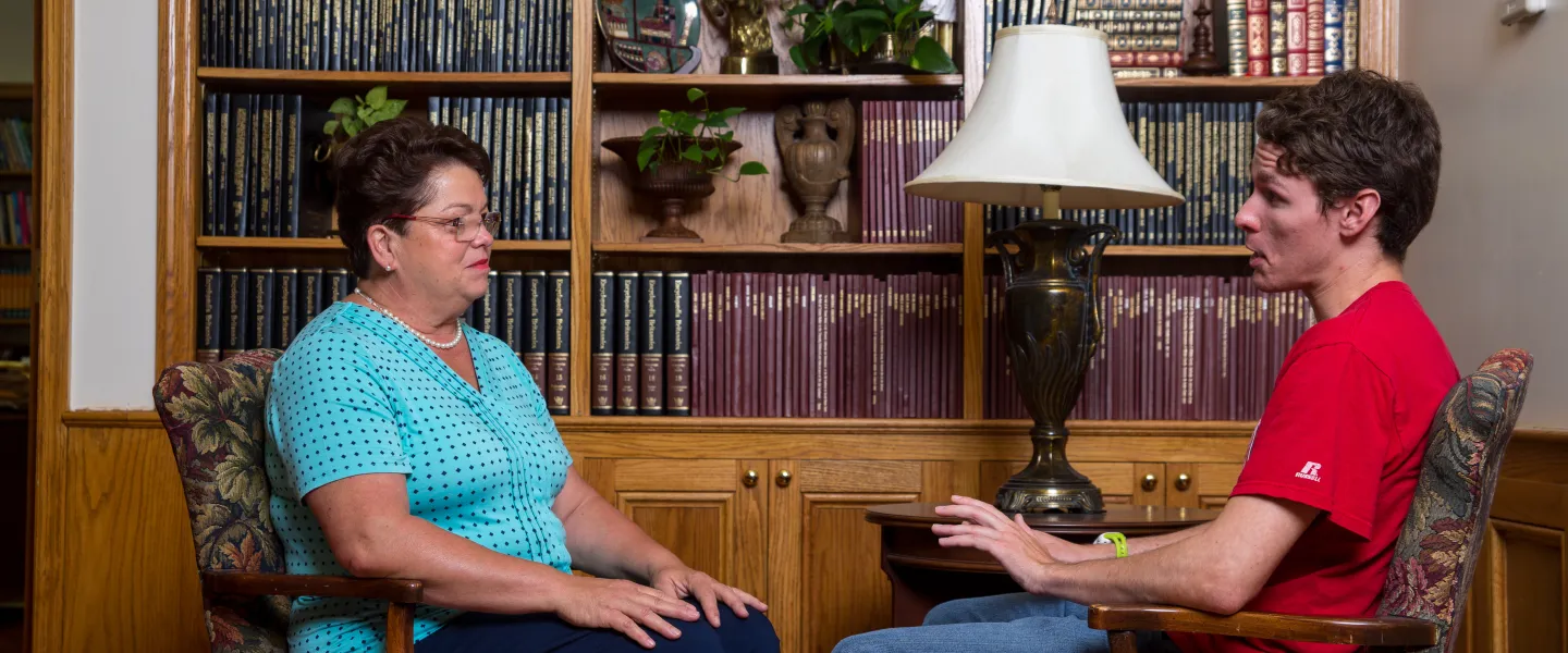 A counselor speaking with a student