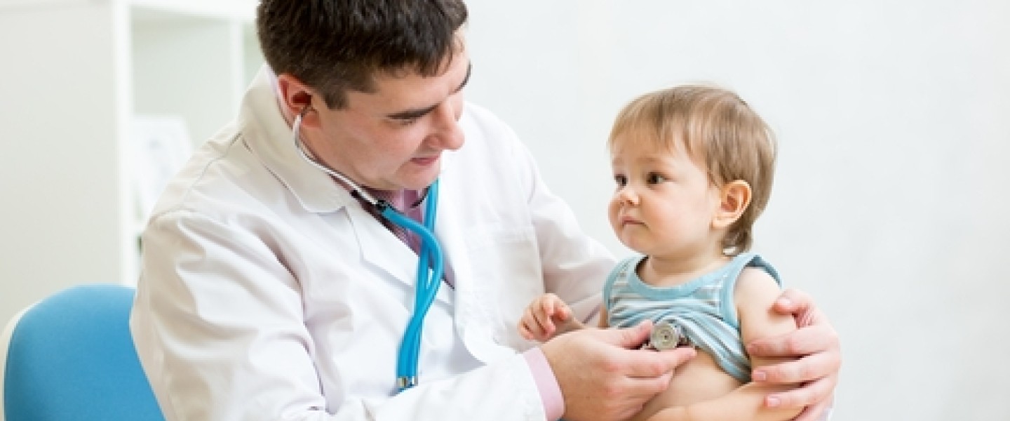 A doctor using a stethoscope on a child
