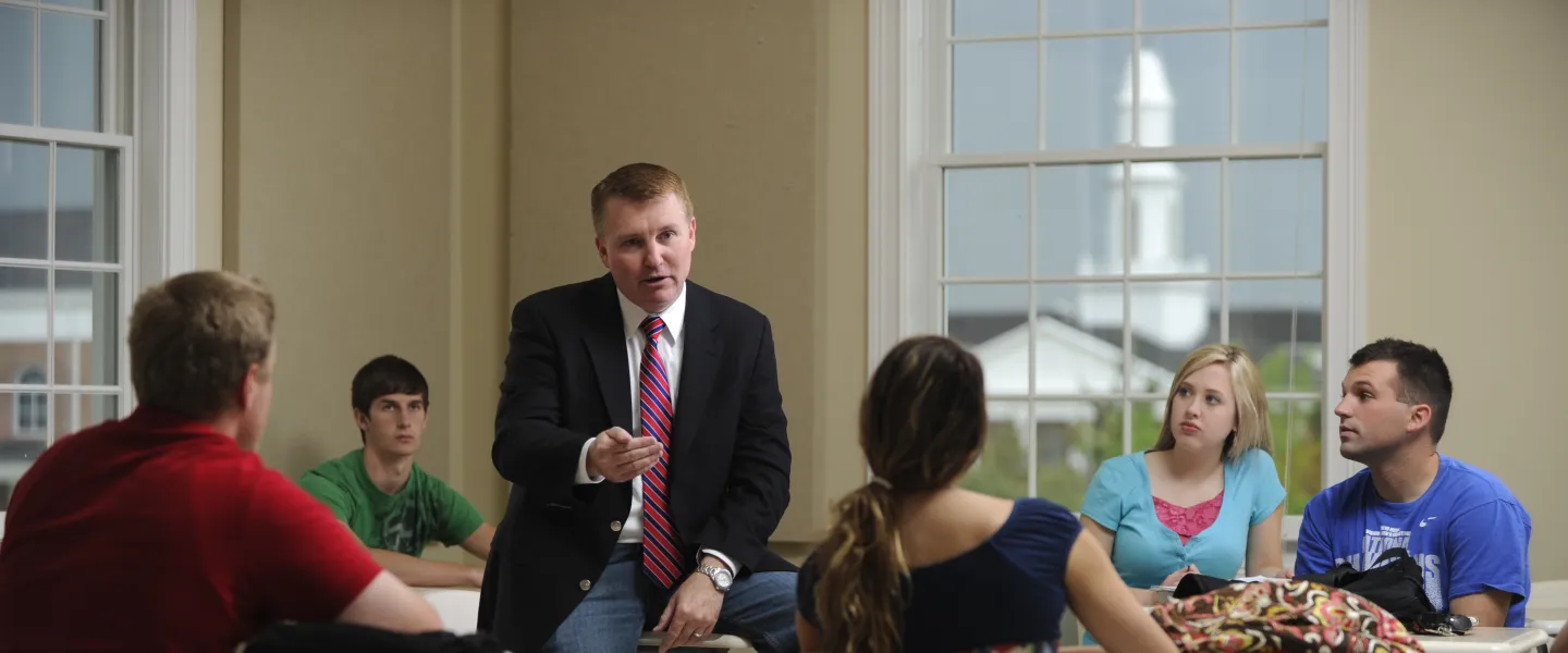 A man speaking to a class 