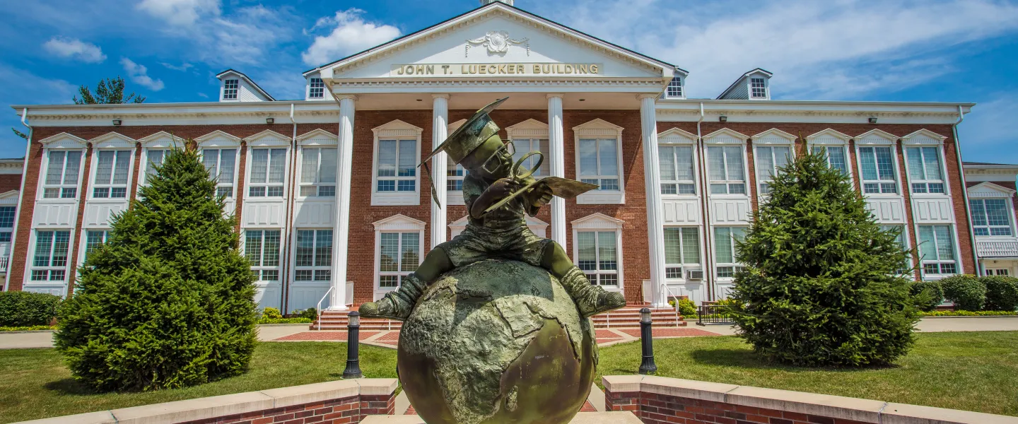 Bronze statue in front of a campus building