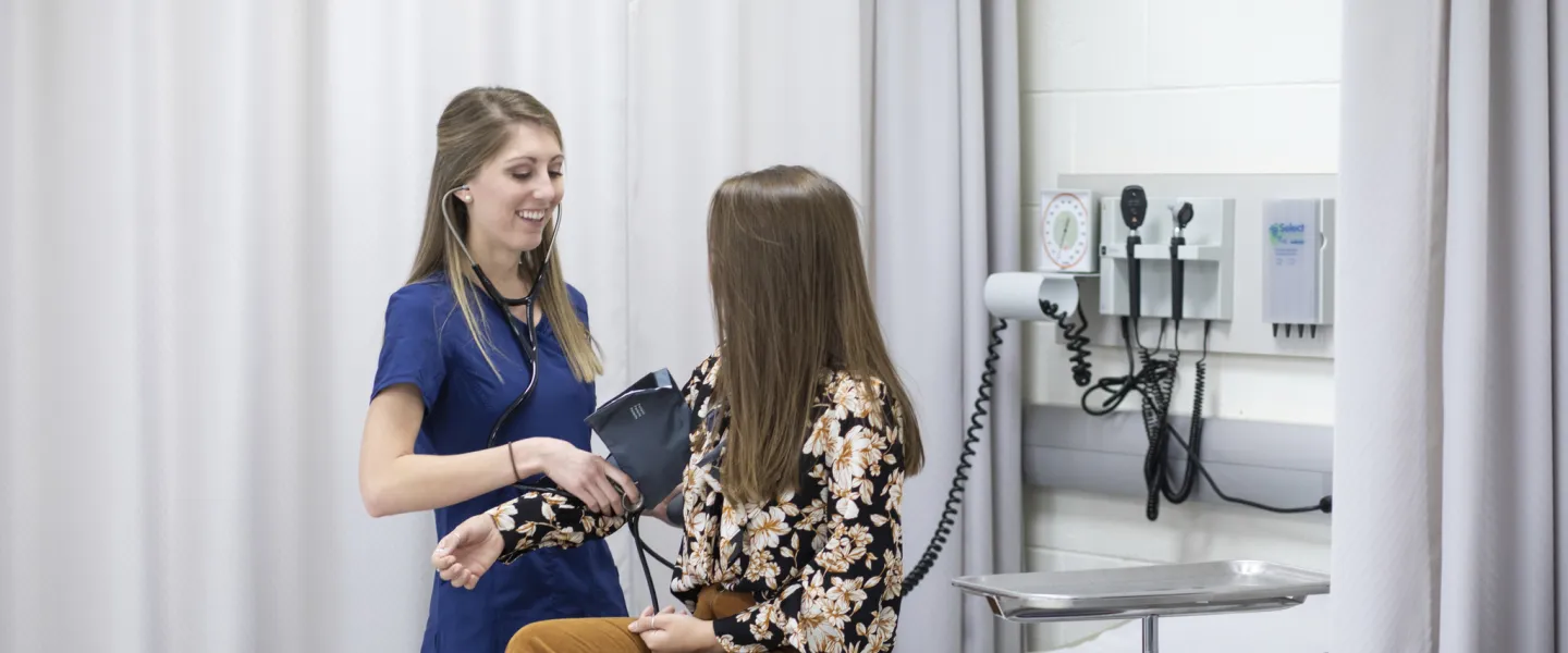 A nurse taking a patient's blood pressure