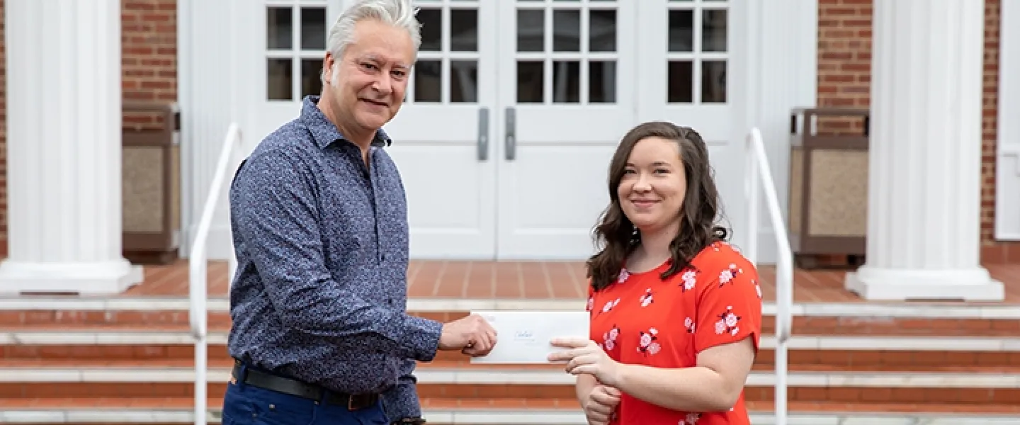 Two people holding an envelope 