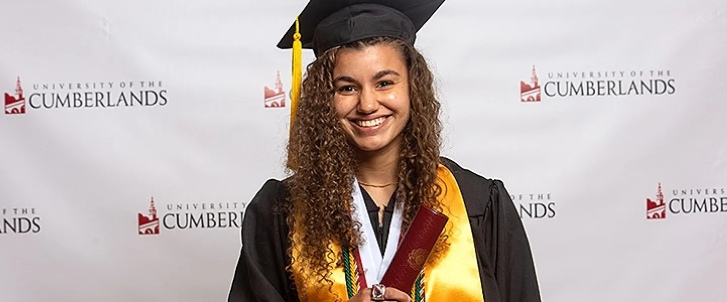 A student wearing a cap and gown
