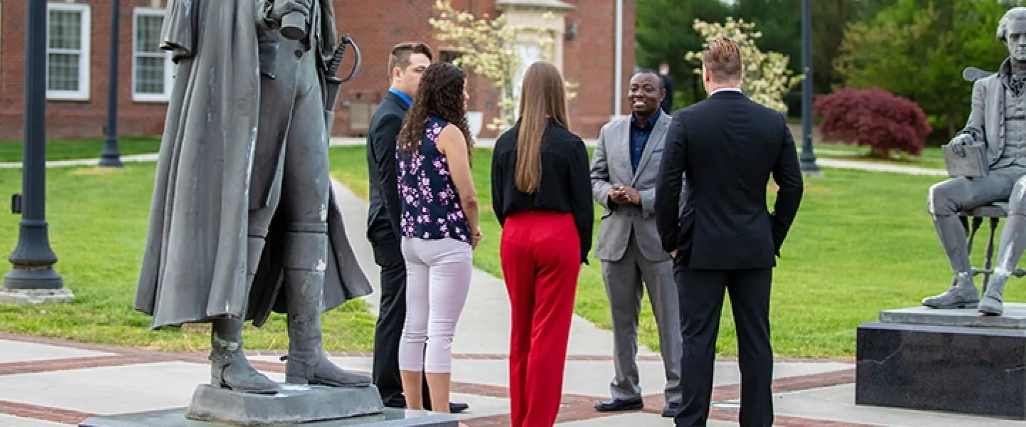 Several people standing outside having a conversation